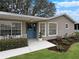 Inviting front porch with blue door and white railing at 25141 Clifford Hl, Leesburg, FL 34748