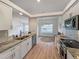 Open concept kitchen with granite countertops and stainless steel appliances at 25141 Clifford Hl, Leesburg, FL 34748