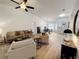 Open concept living room with hardwood floors and a neutral color palette at 25141 Clifford Hl, Leesburg, FL 34748