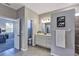 Main bathroom with white vanity and shower at 26633 Otter Creek Ln, Leesburg, FL 34748