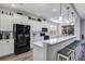 Modern kitchen with white cabinets and black appliances at 26633 Otter Creek Ln, Leesburg, FL 34748