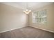 Bright dining room featuring a chandelier and large window at 2747 Spicebush Loop, Apopka, FL 32712