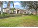 House exterior showcasing a well-manicured lawn and landscaping at 2747 Spicebush Loop, Apopka, FL 32712