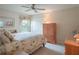 Charming bedroom with floral bedding and built in wooden dresser at 27504 Stoney Brook Dr, Leesburg, FL 34748