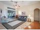 Spacious living area featuring hardwood floors, a comfy seating arrangement, and access to a sunroom at 27504 Stoney Brook Dr, Leesburg, FL 34748