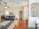 Bright living room with hardwood floors, a comfy couch, and access to a sunroom at 27504 Stoney Brook Dr, Leesburg, FL 34748
