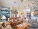 Relaxing living room with leather furniture and access to a screened-in patio at 27504 Stoney Brook Dr, Leesburg, FL 34748