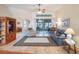 Living room with hardwood floors, a ceiling fan, comfortable seating, and access to a lanai at 27504 Stoney Brook Dr, Leesburg, FL 34748