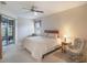 Main bedroom with king-size bed and sliding doors to backyard at 27504 Stoney Brook Dr, Leesburg, FL 34748