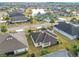 Aerial view of a house with a screened-in porch, and a spacious backyard at 3074 Salerno Ln, The Villages, FL 32163