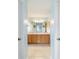 Bathroom with double vanity, wood cabinets, and a large shower at 3200 Woodridge Dr, The Villages, FL 32162