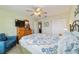 Bright bedroom with a queen bed and wood furniture at 3200 Woodridge Dr, The Villages, FL 32162