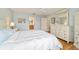Bedroom with white furniture, hardwood floors and access to bathroom at 3200 Woodridge Dr, The Villages, FL 32162