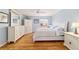 Main bedroom with hardwood floors, white furniture, and ample closet space at 3200 Woodridge Dr, The Villages, FL 32162