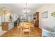 Dining room with wood table and chairs, hardwood floors and chandelier at 3200 Woodridge Dr, The Villages, FL 32162