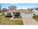 Charming single-story house with attached garage and manicured lawn at 3200 Woodridge Dr, The Villages, FL 32162