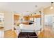 Kitchen with island, wood cabinets, and breakfast bar seating at 3200 Woodridge Dr, The Villages, FL 32162