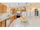 Well-equipped kitchen featuring oak cabinets and stainless steel appliances at 3200 Woodridge Dr, The Villages, FL 32162