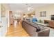 Spacious living room with hardwood floors and a brown leather couch at 3200 Woodridge Dr, The Villages, FL 32162
