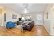 Living room with hardwood floors, blue armchair, and a flatscreen TV at 3200 Woodridge Dr, The Villages, FL 32162