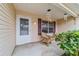 Cozy front porch with rocking chairs and potted plants at 3200 Woodridge Dr, The Villages, FL 32162