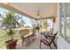 Relaxing screened porch with wicker furniture and lush landscaping views at 3200 Woodridge Dr, The Villages, FL 32162