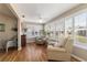 Spacious sunroom featuring hardwood floors, ample natural light, and comfortable seating at 3200 Woodridge Dr, The Villages, FL 32162