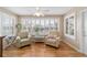 Sunroom with two armchairs and multiple windows at 3200 Woodridge Dr, The Villages, FL 32162