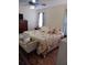 Bright bedroom with king-size bed and plenty of natural light at 32218 Sweet Briar Court, Leesburg, FL 34748