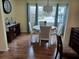 Charming dining area with wood floors and a large window at 32218 Sweet Briar Court, Leesburg, FL 34748