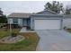 Cute Florida home with attached garage and landscaped yard at 32218 Sweet Briar Court, Leesburg, FL 34748