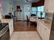 Bright kitchen with white cabinets, granite counters, and stainless steel appliances at 32218 Sweet Briar Court, Leesburg, FL 34748