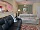 Living room with leather and fabric sofas, and decorative accents at 32218 Sweet Briar Court, Leesburg, FL 34748