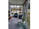 Relaxing screened porch with wicker furniture and plants at 32218 Sweet Briar Court, Leesburg, FL 34748