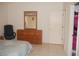 Bedroom with dresser, mirror and closet at 3243 Mansfield St, The Villages, FL 32162