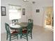 Dining area with green table and four chairs at 3243 Mansfield St, The Villages, FL 32162