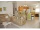Open kitchen with oak cabinets, gas stove, and breakfast bar at 3243 Mansfield St, The Villages, FL 32162
