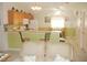 Open kitchen with oak cabinets and breakfast bar at 3243 Mansfield St, The Villages, FL 32162