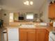 Kitchen with oak cabinets, double sink, and breakfast bar at 3243 Mansfield St, The Villages, FL 32162