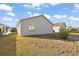 Home's backyard features a grassy lawn and a view of the house's back exterior at 3347 Empire Ave, The Villages, FL 32163