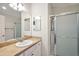 Bathroom with single sink vanity, shower, and linen storage at 3347 Empire Ave, The Villages, FL 32163