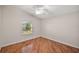 Bedroom with wood flooring, window, and ceiling fan at 3347 Empire Ave, The Villages, FL 32163