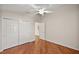 Bright bedroom featuring wood flooring and double door closet at 3347 Empire Ave, The Villages, FL 32163