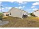 Rear exterior view of house and yard at 3347 Empire Ave, The Villages, FL 32163