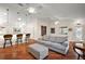 Open living room with hardwood floors and kitchen island at 3347 Empire Ave, The Villages, FL 32163