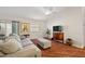 Living room with hardwood floors, a couch, and a view to the kitchen at 3347 Empire Ave, The Villages, FL 32163