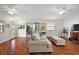 Living room with hardwood floors, access to the backyard and ceiling fan at 3347 Empire Ave, The Villages, FL 32163