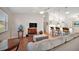 Open living room with hardwood floors, couch, and view into the kitchen at 3347 Empire Ave, The Villages, FL 32163