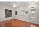 Bright and airy living room with hardwood floors and large artwork at 3347 Empire Ave, The Villages, FL 32163