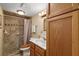 Bathroom with tiled shower/tub combo and wood vanity at 34205 Island Dr, Leesburg, FL 34788